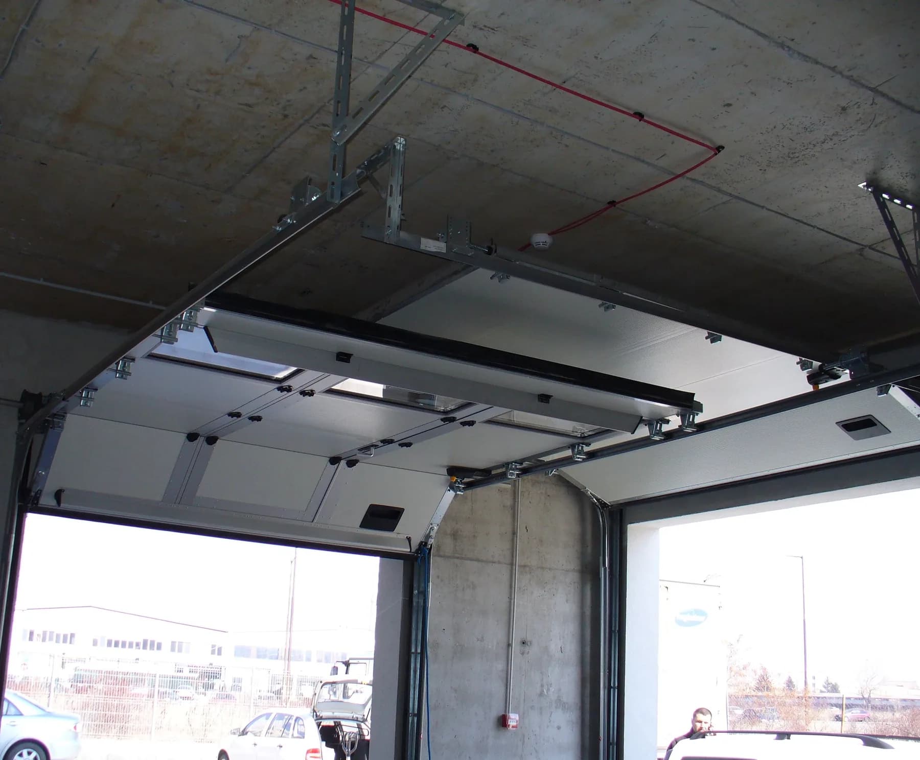 An installed sectional door and its gear, seen from inside